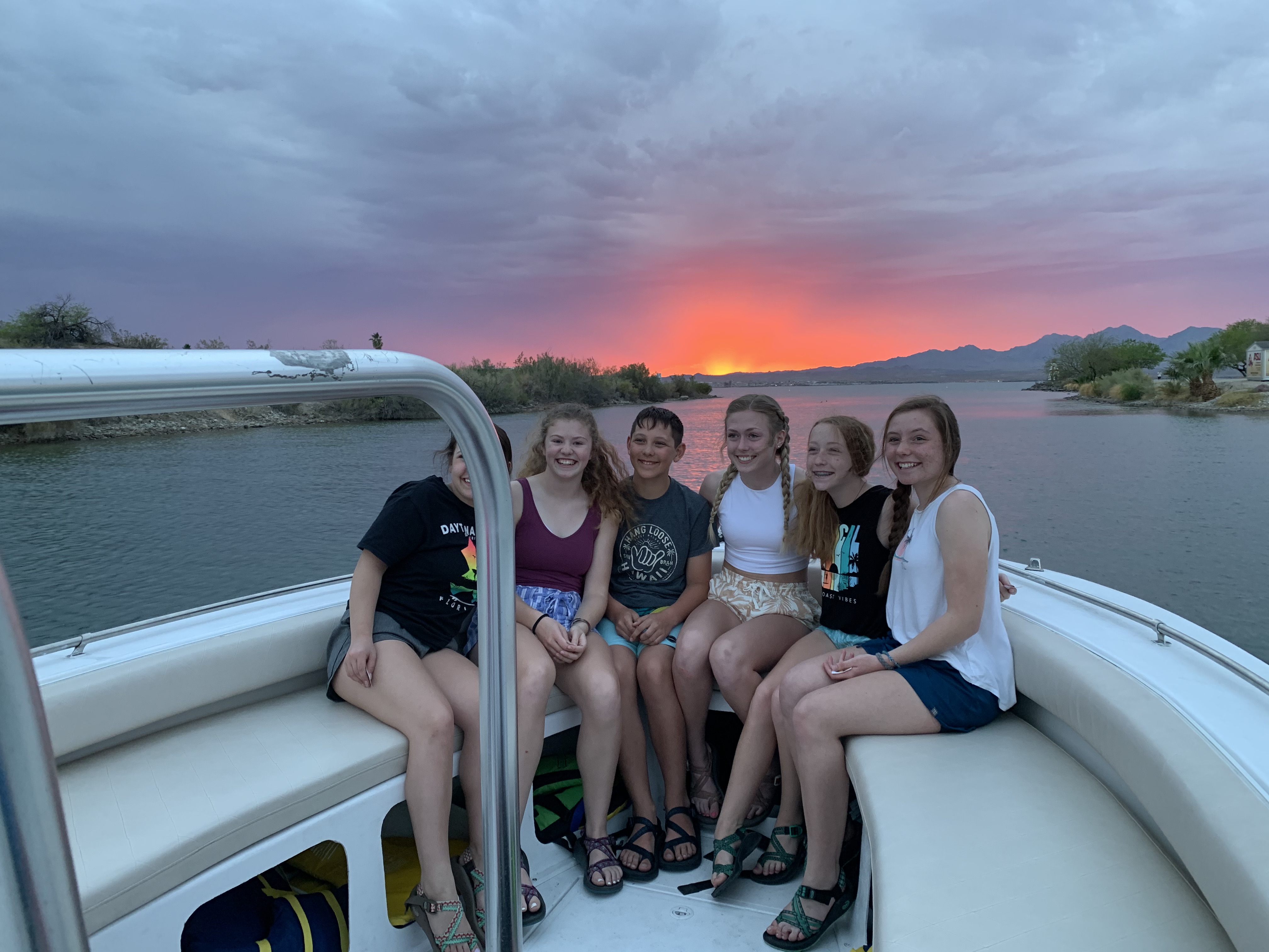 Group enjoying sunset parasailing