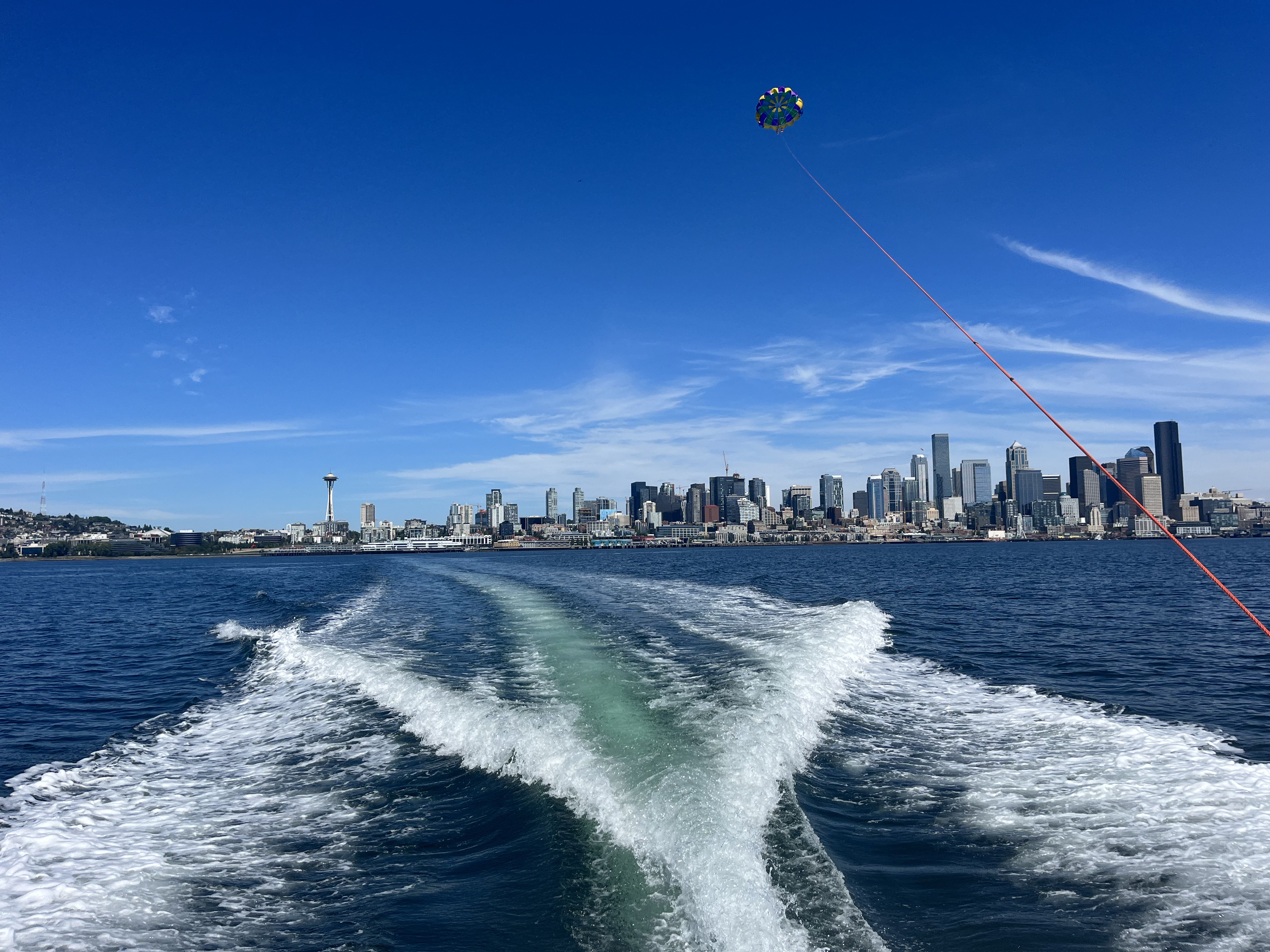 Far-out colored parachute soaring above the Space Needle
